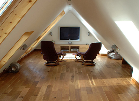 Bed and home cinema in loft conversion